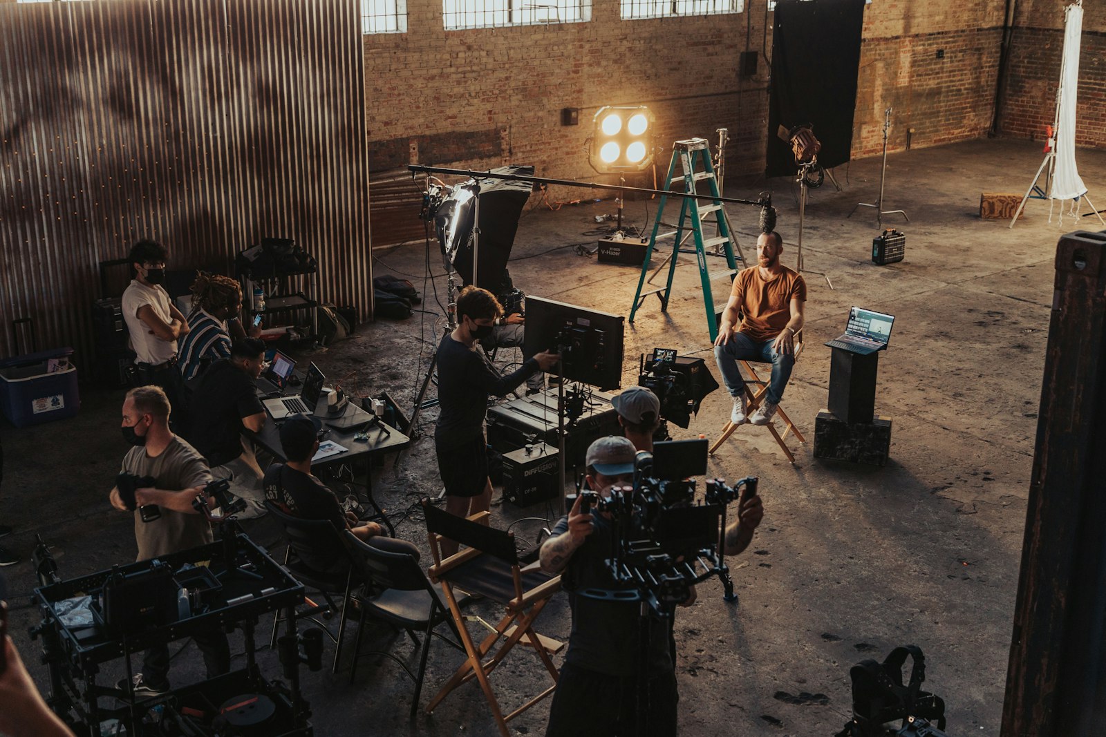 A film crew setting up cameras and lights on set